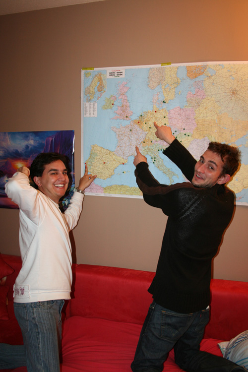Mike and Benoît pointing where they are from and live now
