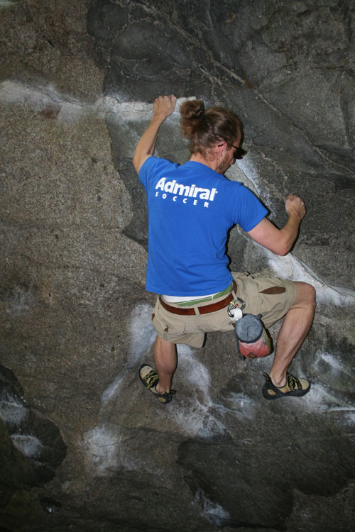 Seb climbing a rock
